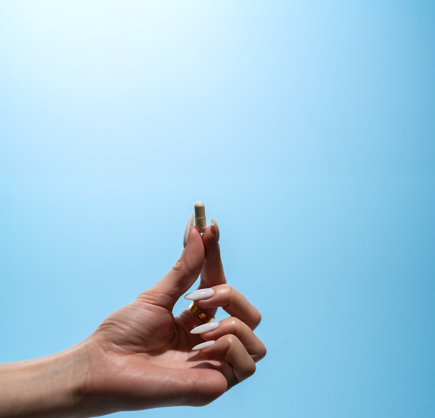 Hand Holding Biotic Capsule
