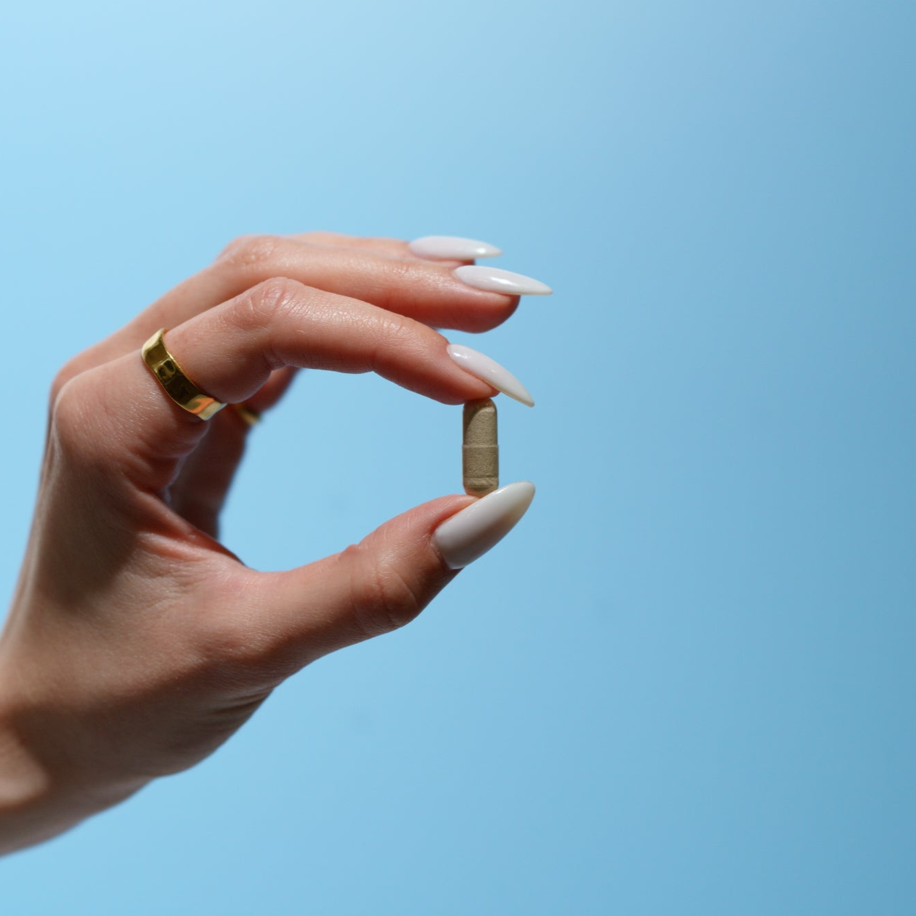 hand holding probiotic capsule