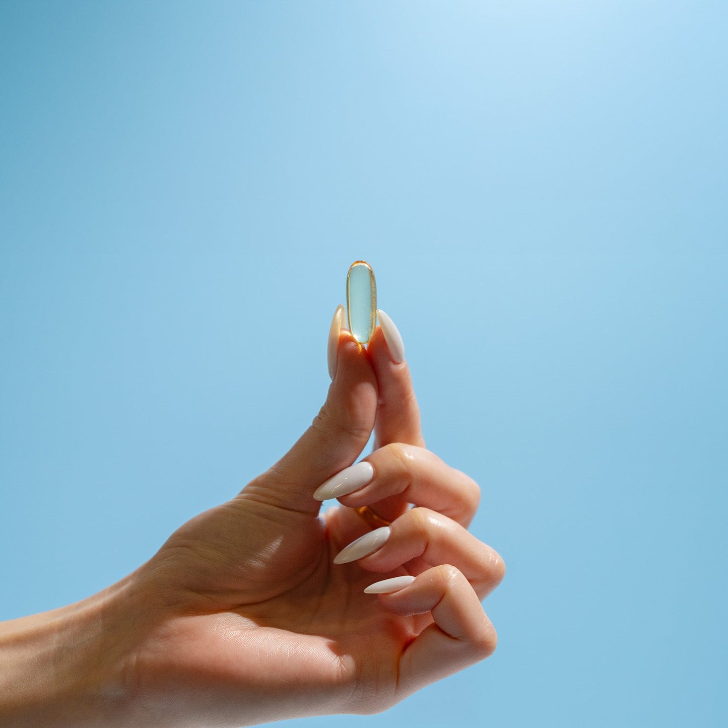 Hand Holding Omega 3 Softgel