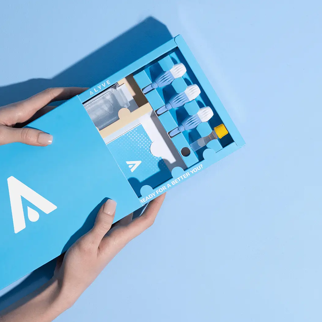 a hand holding the blood test kit